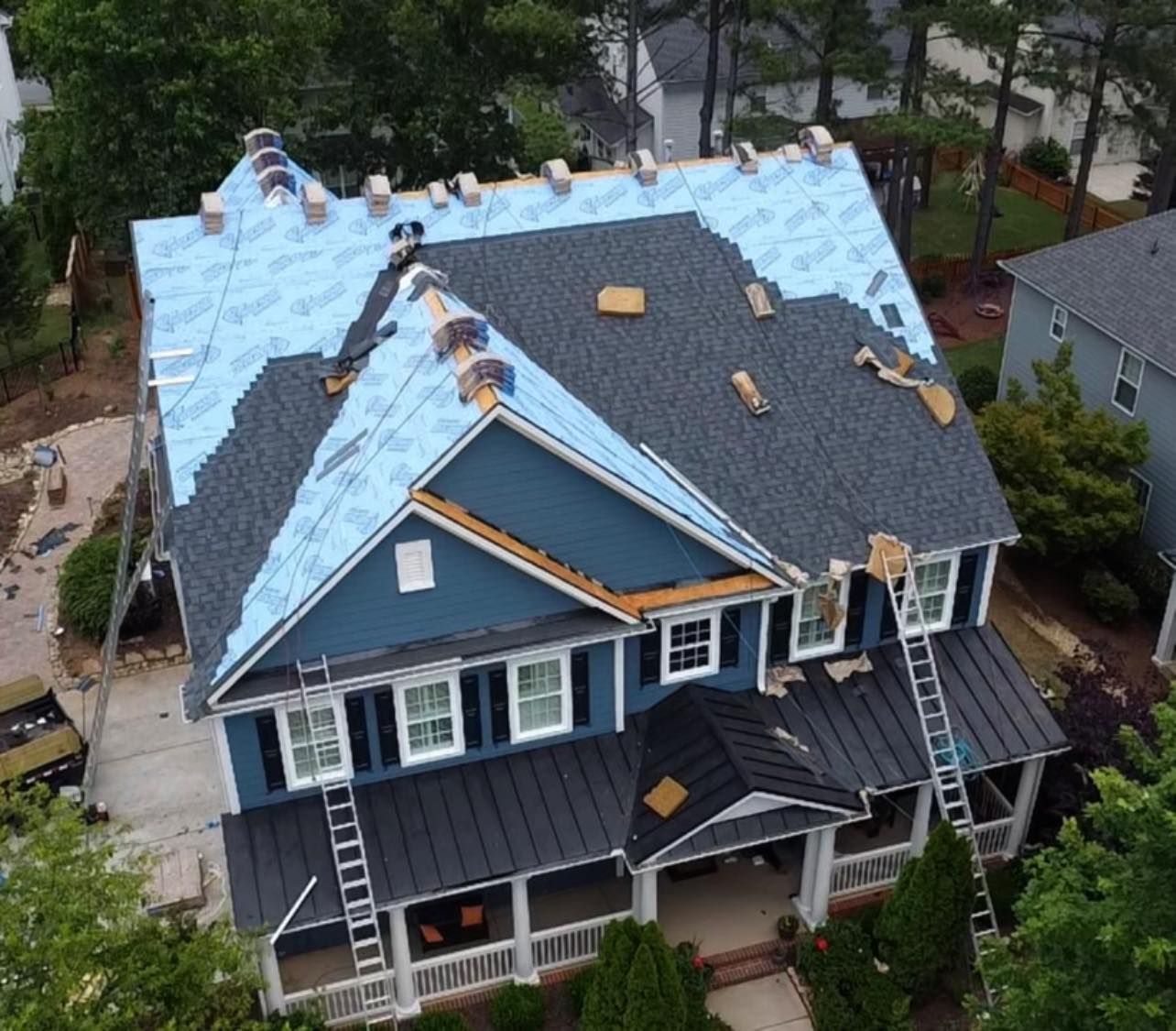 An aerial view of a house with a roof being installed
