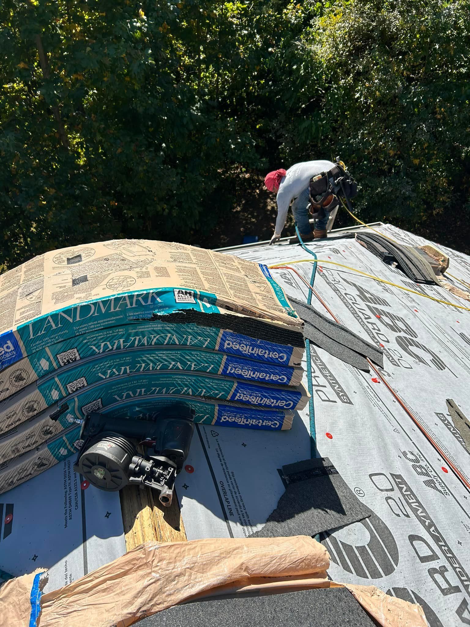 A man is working on the roof of a house.