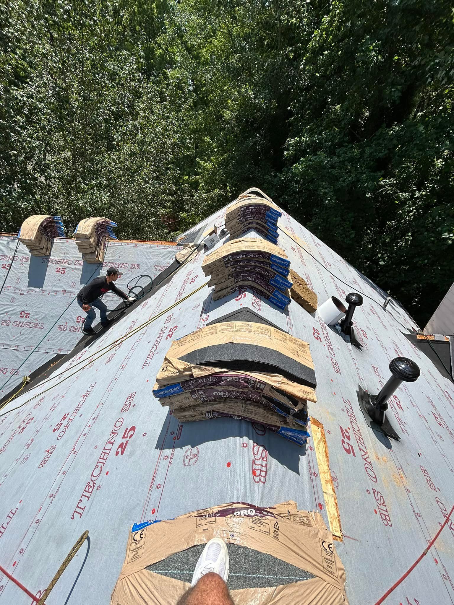 A man is working on the roof of a house.