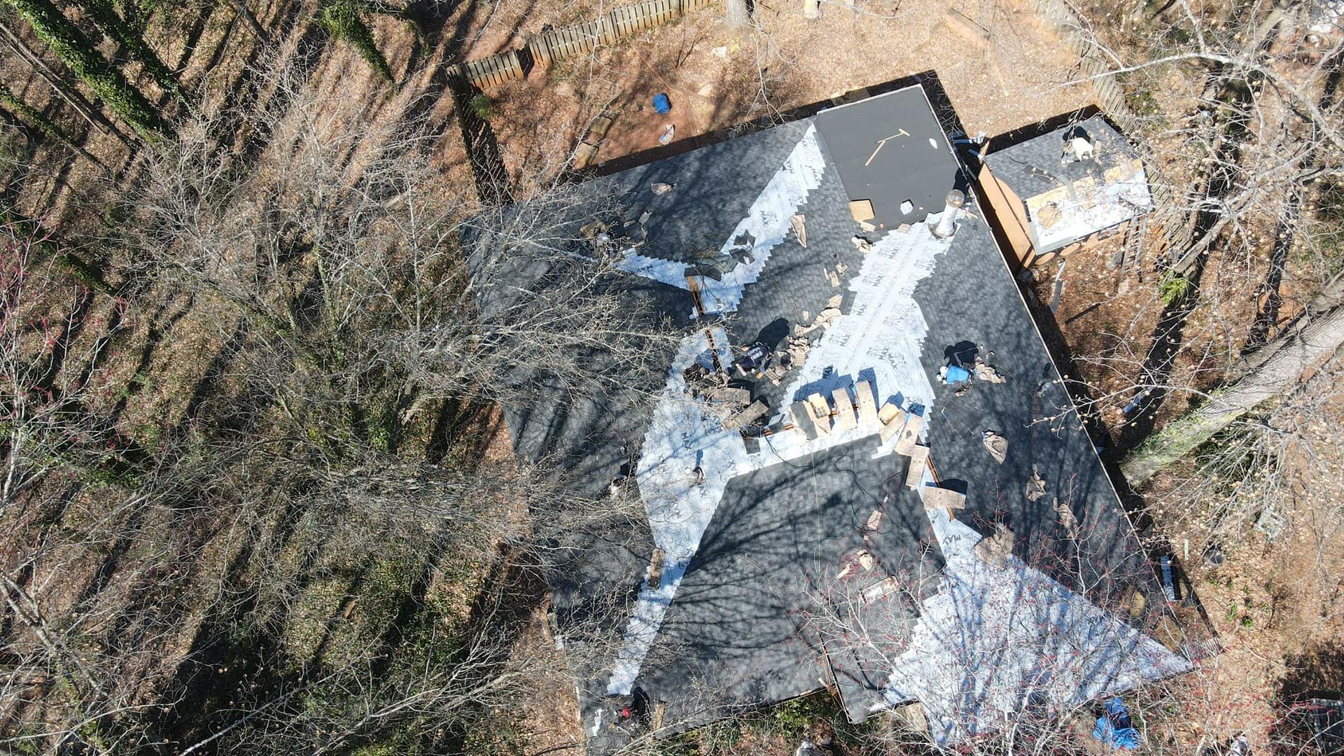 An aerial view of a building in the middle of a forest.