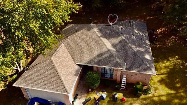 An aerial view of a house with a heart on the roof.