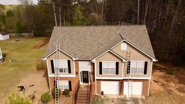 An aerial view of a house with a roof that is being installed.