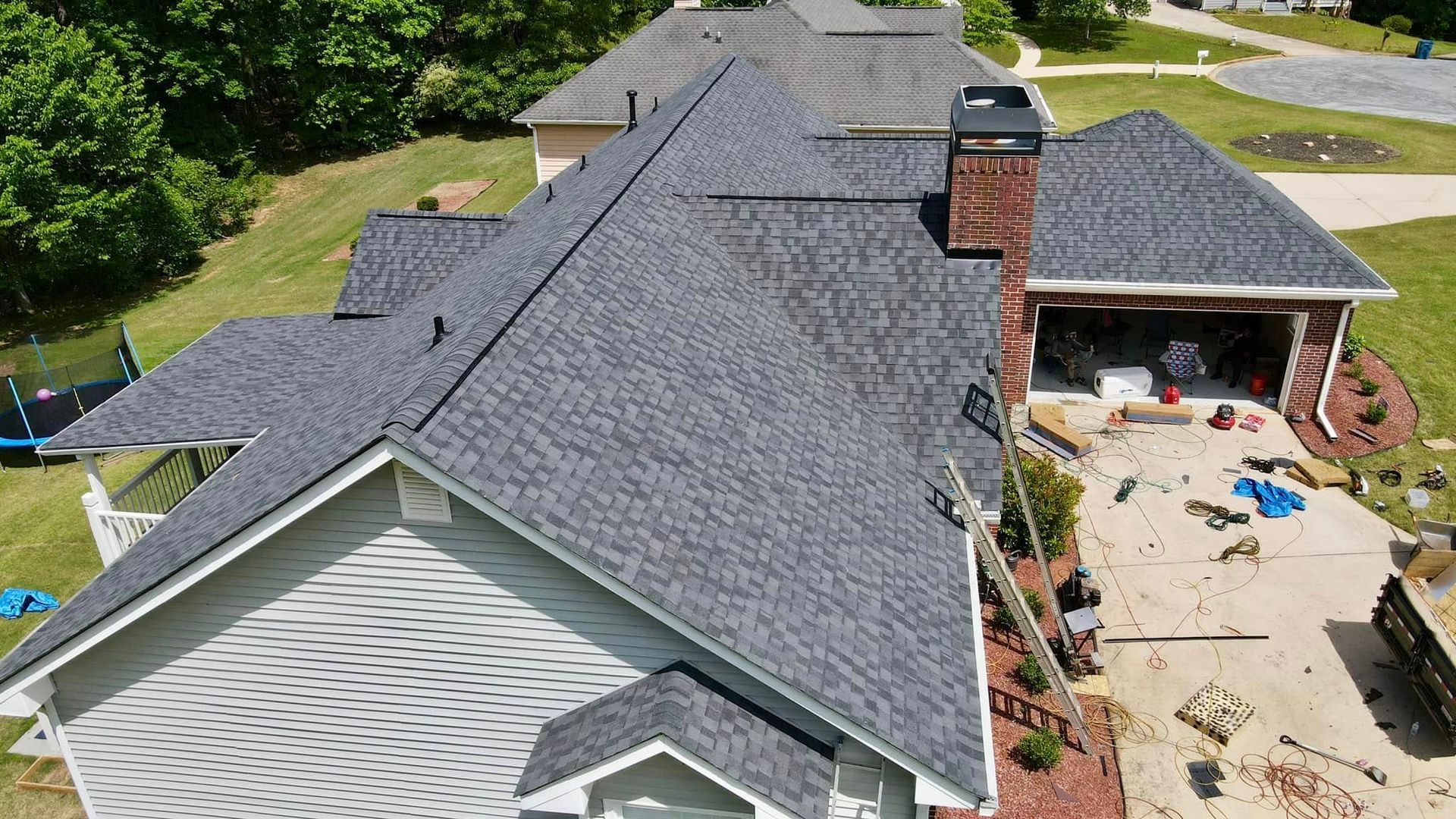 An aerial view of a house with a new roof.