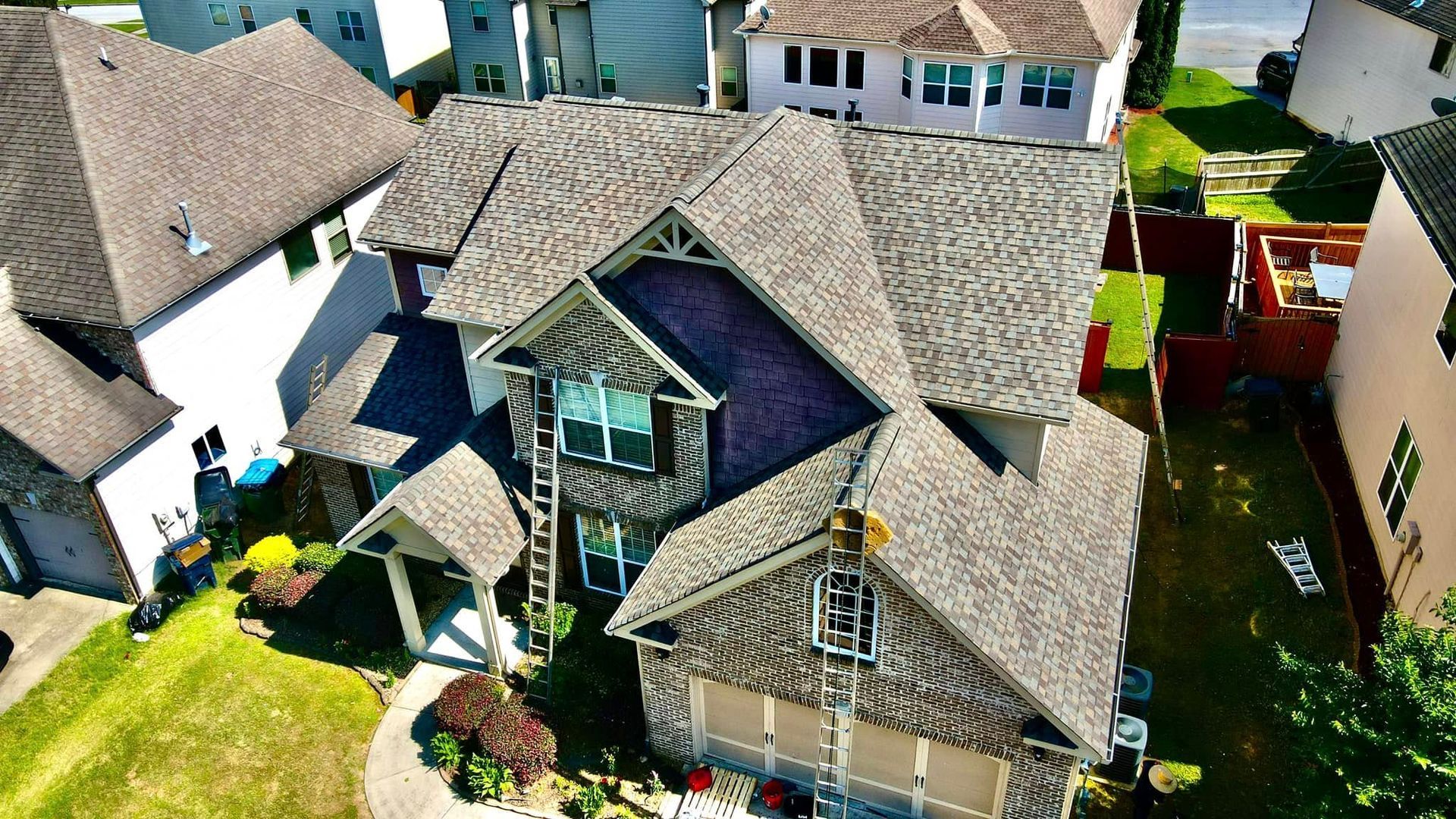 An aerial view of a house with a roof that is covered in shingles.