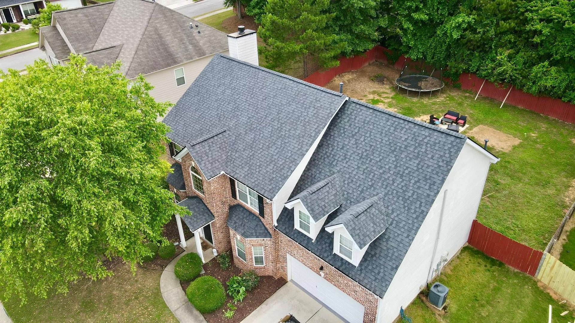 An aerial view of a house with a new roof.