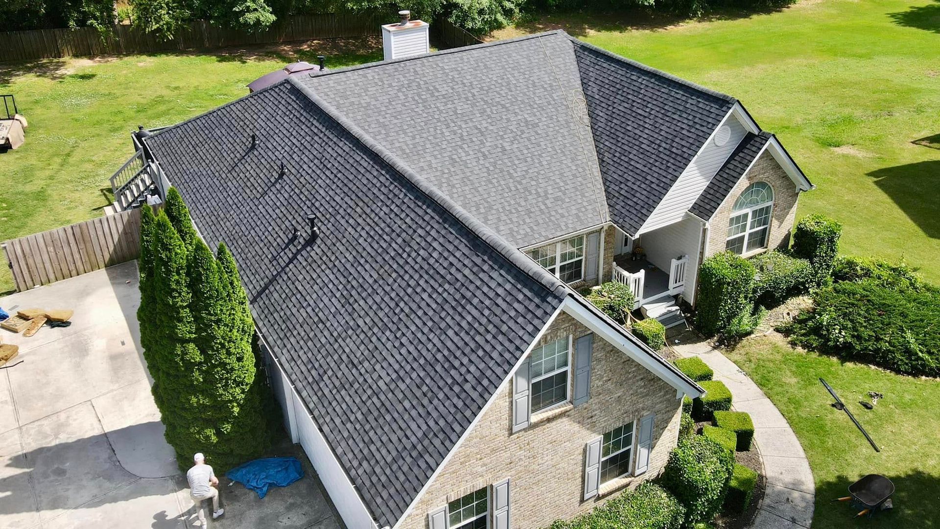 An aerial view of a house with a new roof.