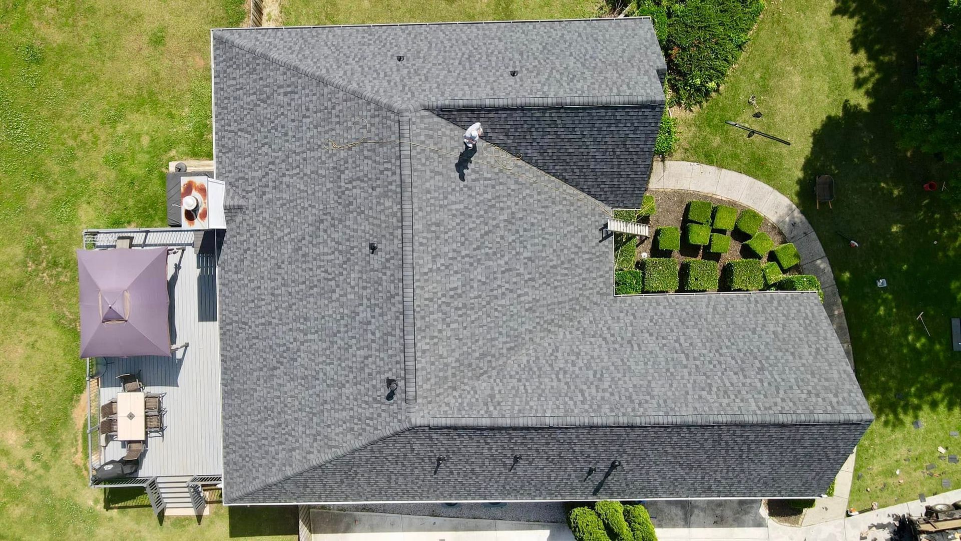An aerial view of a house with a roof and a patio.