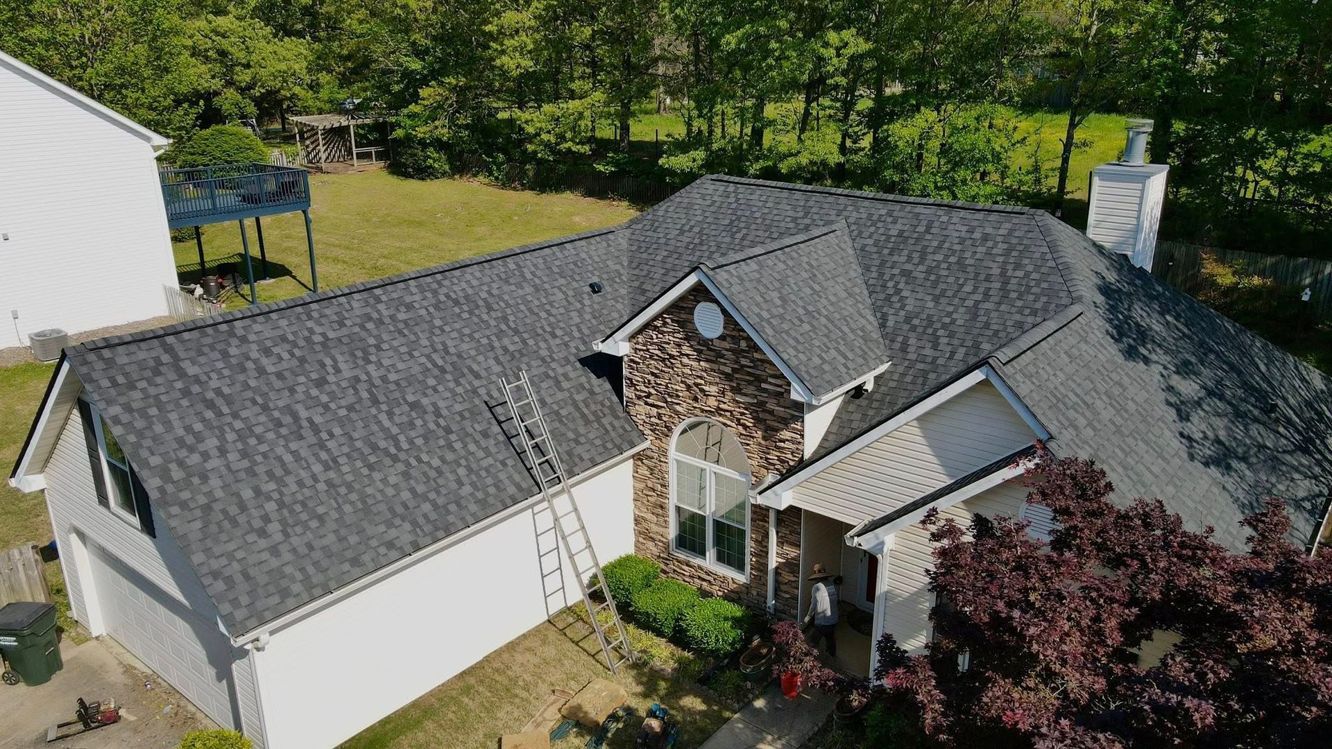 An aerial view of a house with a new roof.