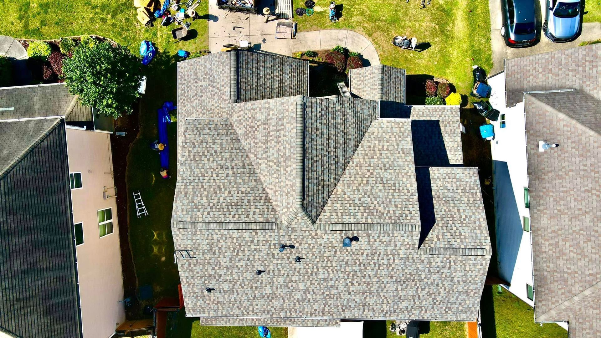An aerial view of a house with a roof that is being repaired.
