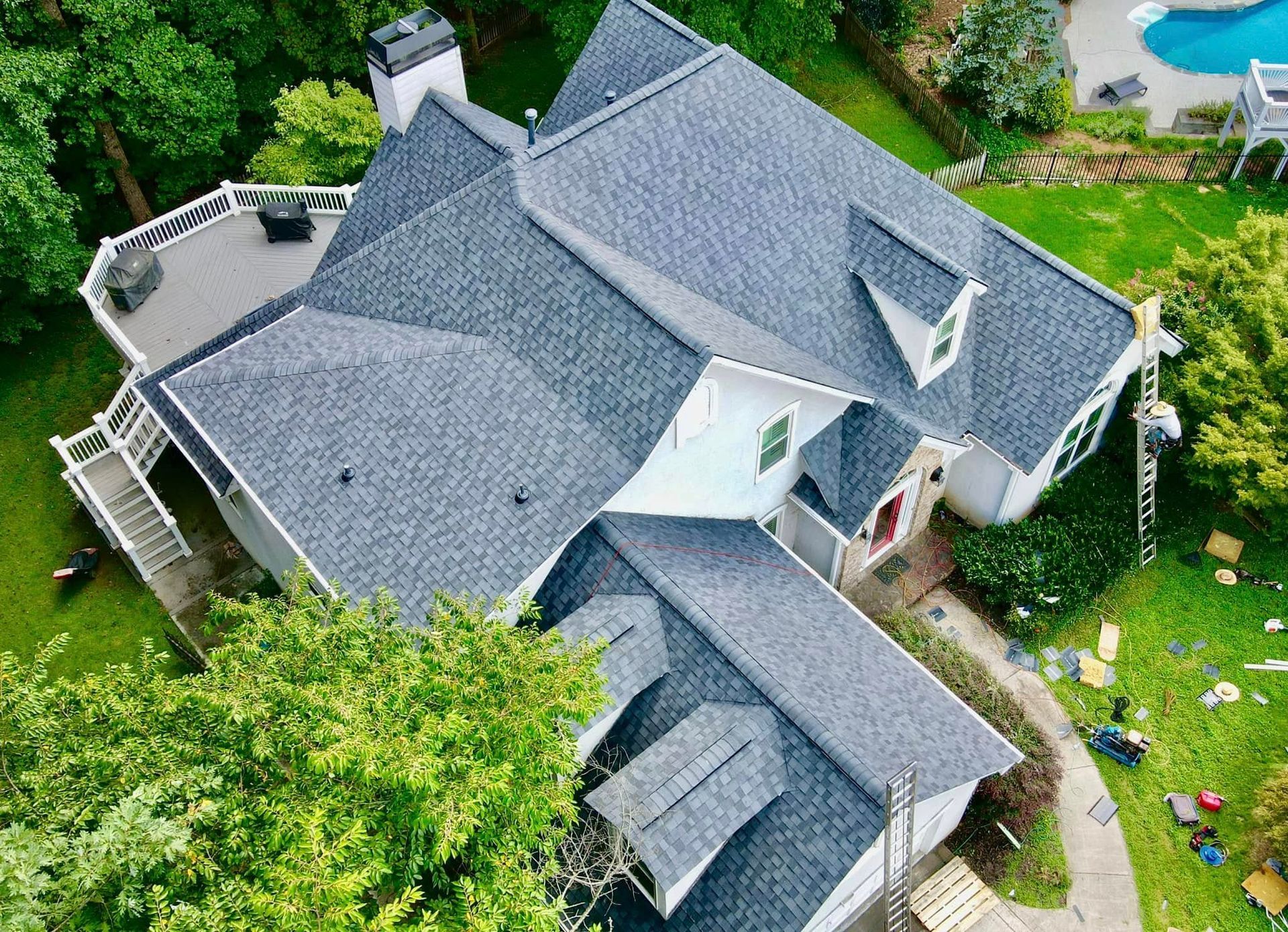 An aerial view of a large house with a new roof.