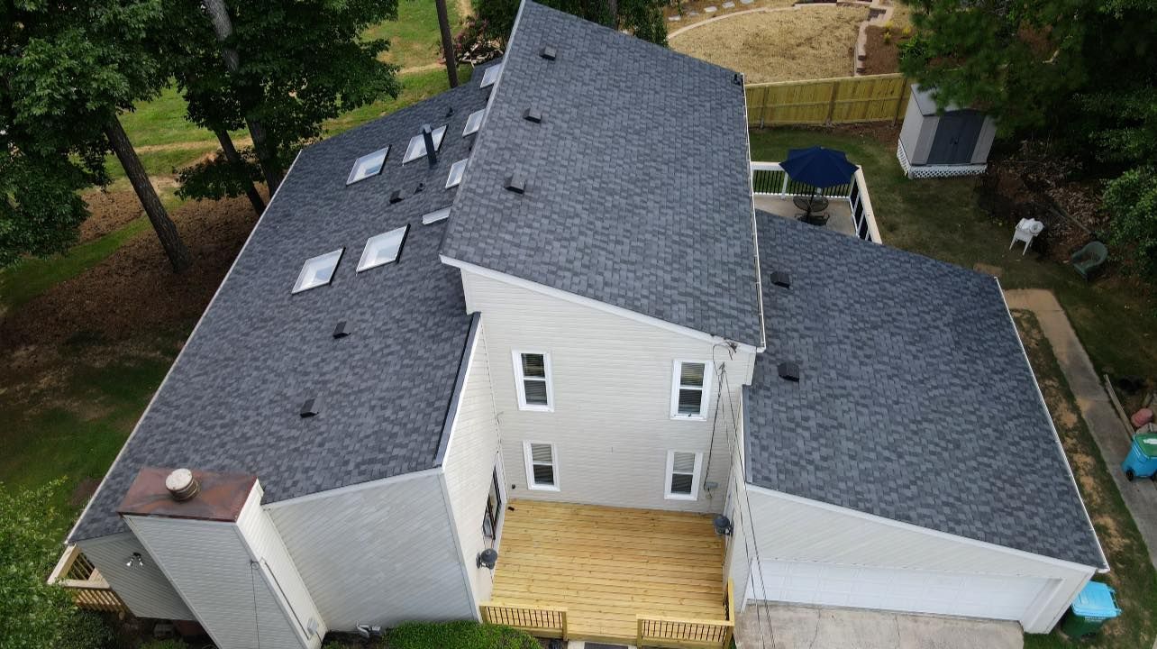 An aerial view of a house with a new roof.