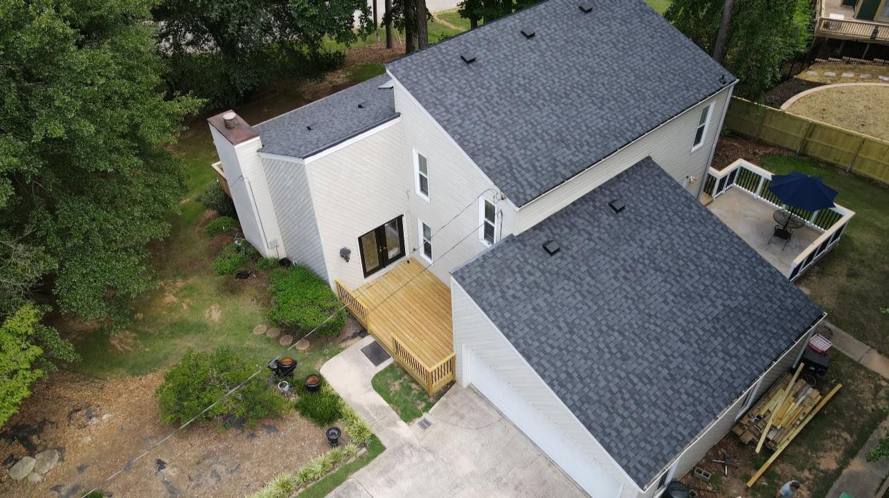 An aerial view of a house with a new roof.