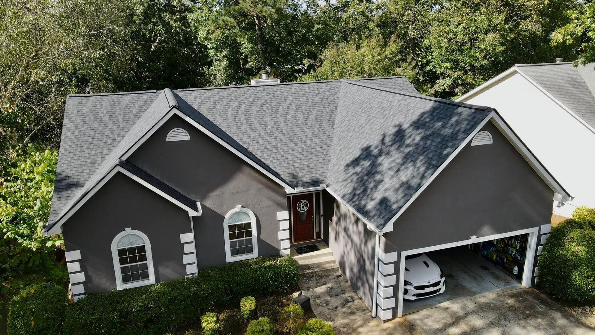 An aerial view of a house with a car parked in the garage.
