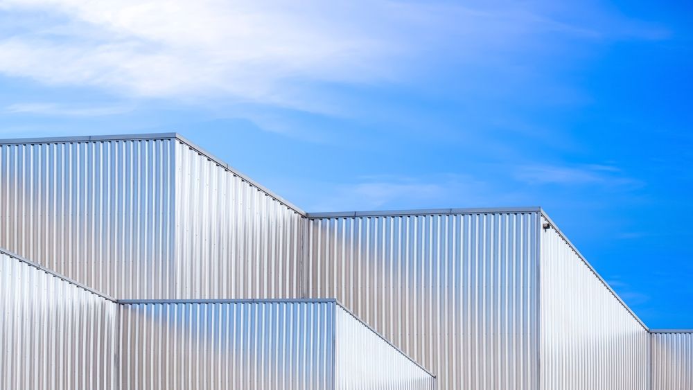The roof of a building with a blue sky in the background.