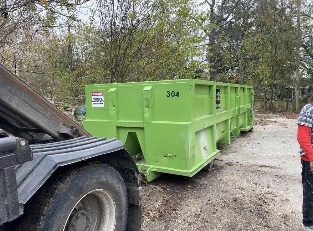 Green dumpster labeled 