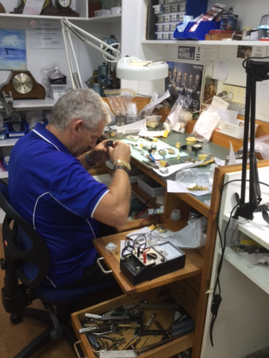 Gold Wristwatch on White Pillow in a Display Case — Coastal Clocks & Watches in Buddina, QLD