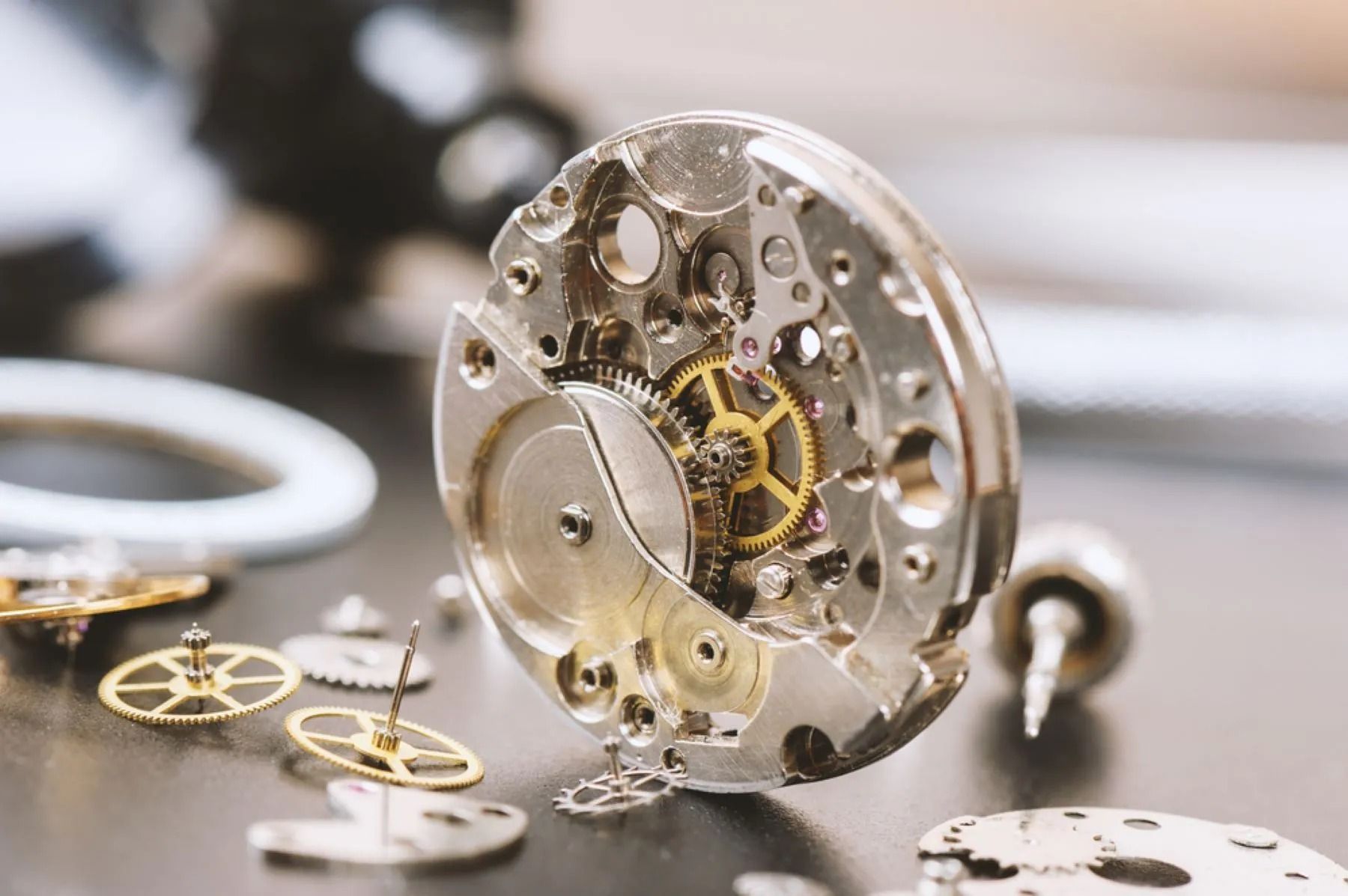 Watch Movement With Gears and Parts Scattered, on a Surface — Coastal Clocks & Watches in Mooloolaba, QLD
