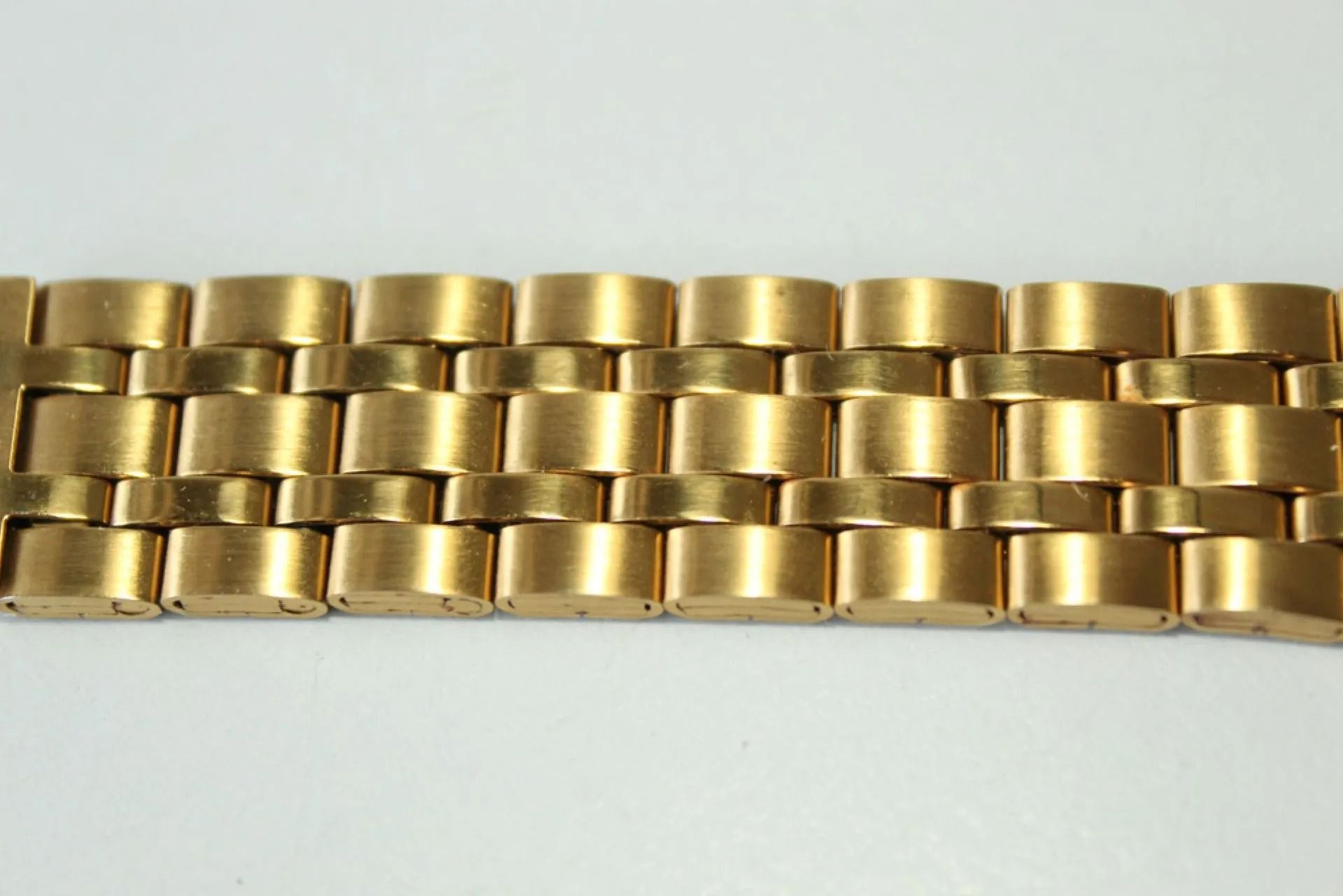 Gold Metal Watch Band Links Arranged in a Grid Pattern — Coastal Clocks & Watches in Mooloolaba, QLD