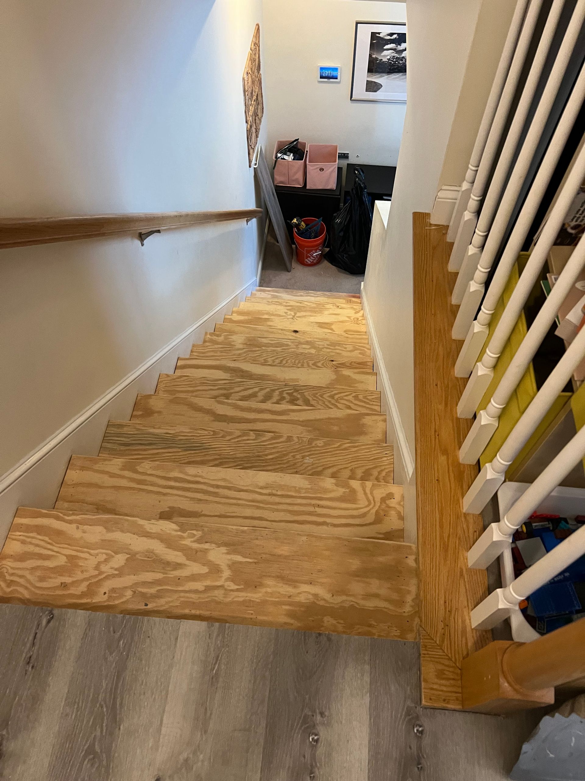 A staircase with a wooden floor and a white railing.
