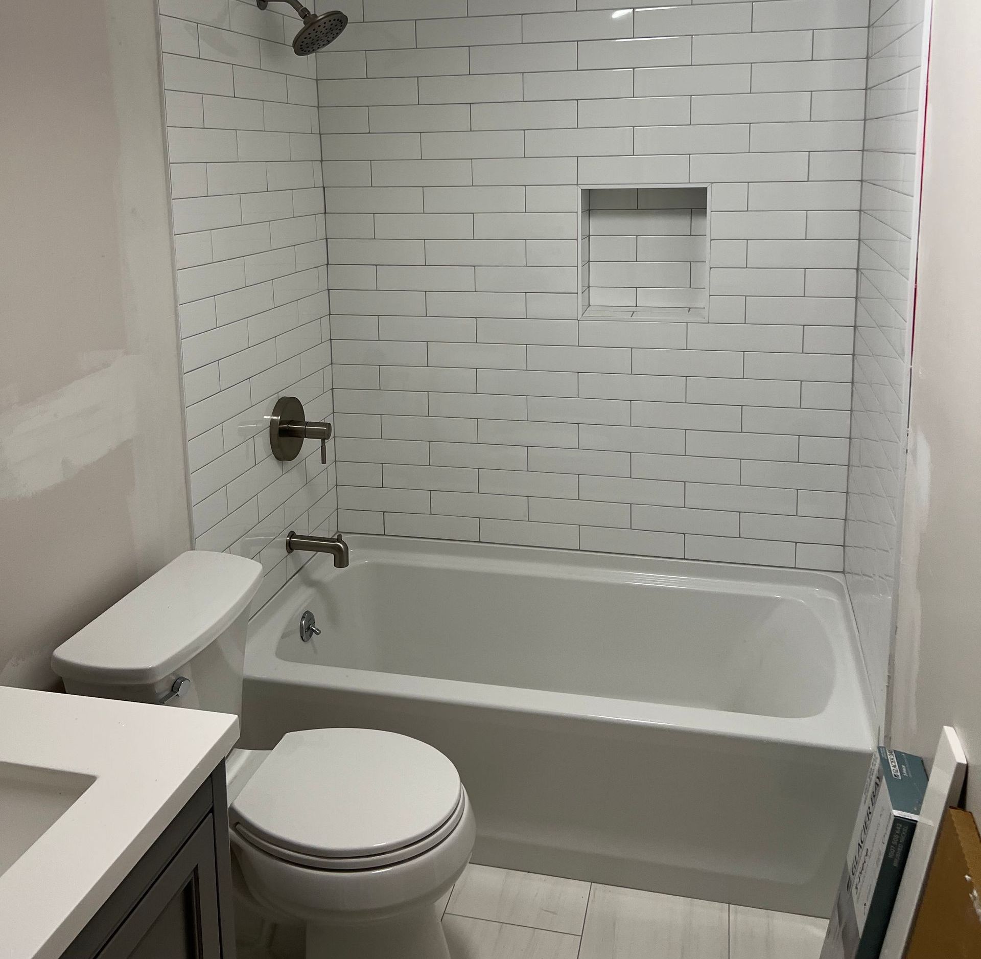 A bathroom with a toilet a tub and a shower