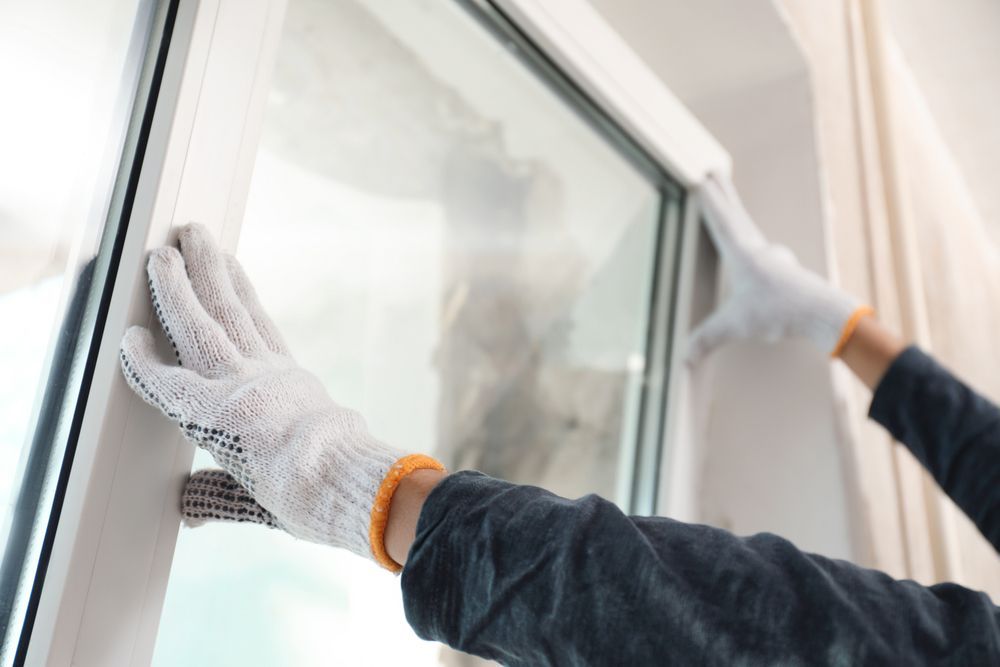 Person Wearing Gloves Installing a Window — Long Jetty Glass in The Entrance, NSW