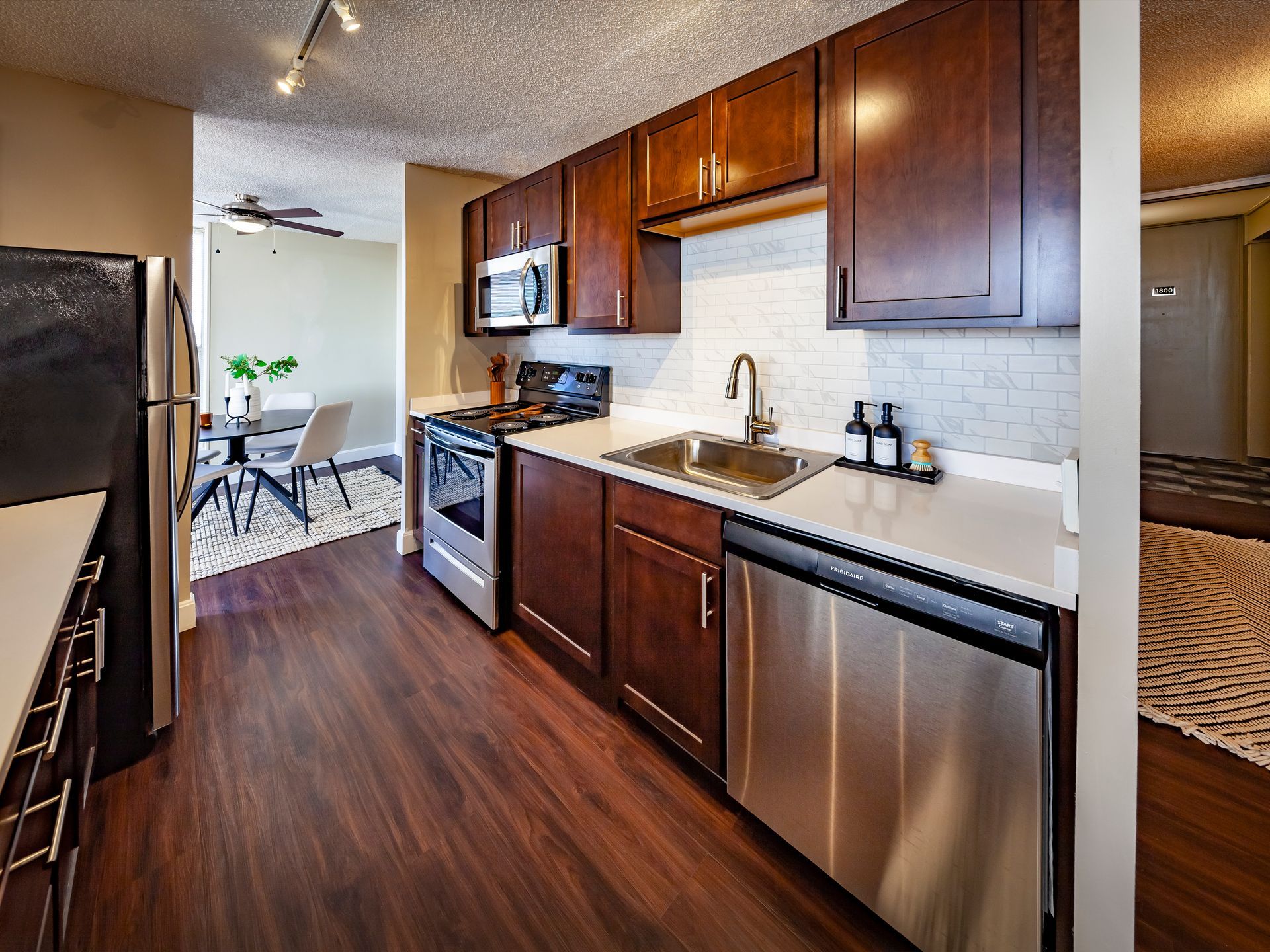 A kitchen with stainless steel appliances and wooden cabinets at  Riley Towers, Indianapolis, IN. 