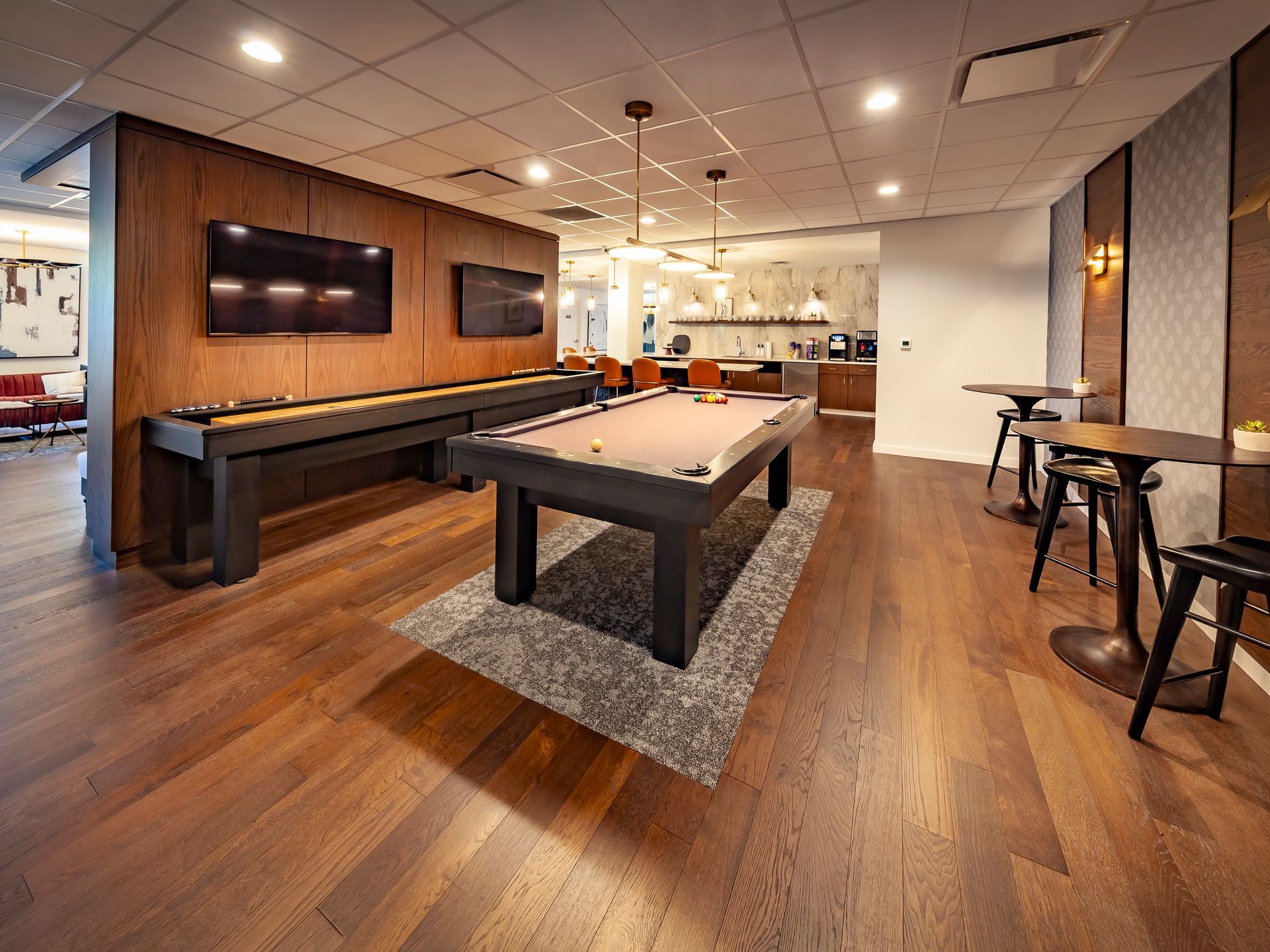 There is a pool table in the middle of the room at  Riley Towers, Indianapolis, IN. 