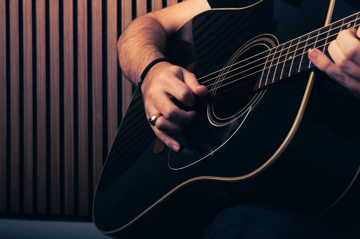 guitar being played with only hands visible