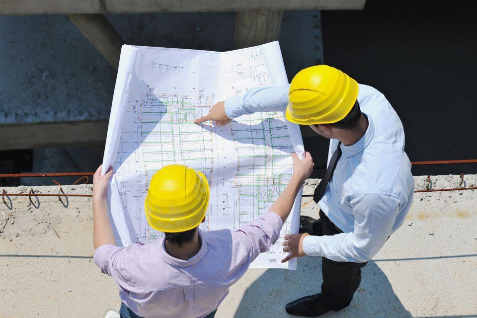 contractor checking the construction drawing