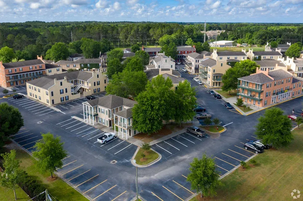 an aerial view of a residential area with lots of buildings and parking lots .
