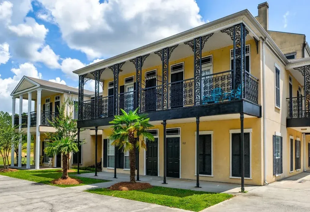 a large house with a lot of windows and balconies is for sale .