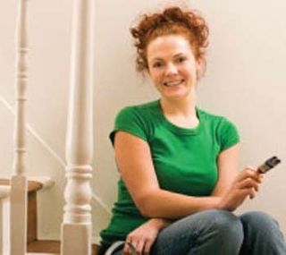 Girl sitting on stairs with paintbrush in hand