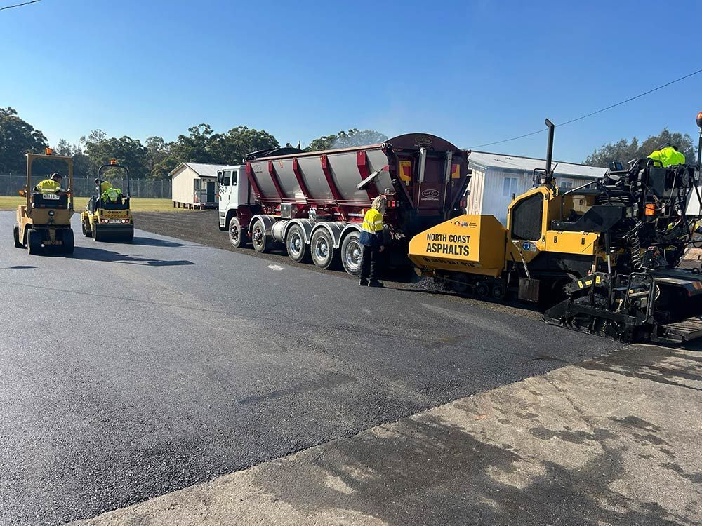 A Group of Construction Workers Are Working on a Road — North Coast Asphalts in Corindi Beach, NSW