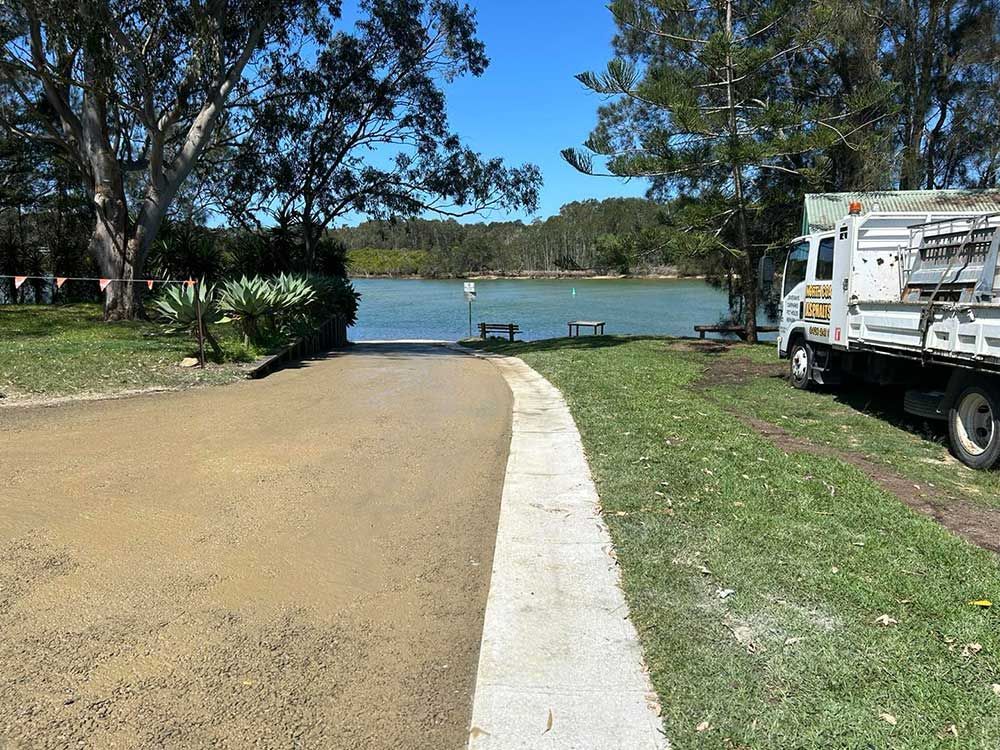 A Truck is Parked on the Side of the Road Next to a Lake — North Coast Asphalts in Clarence Valley, NSW
