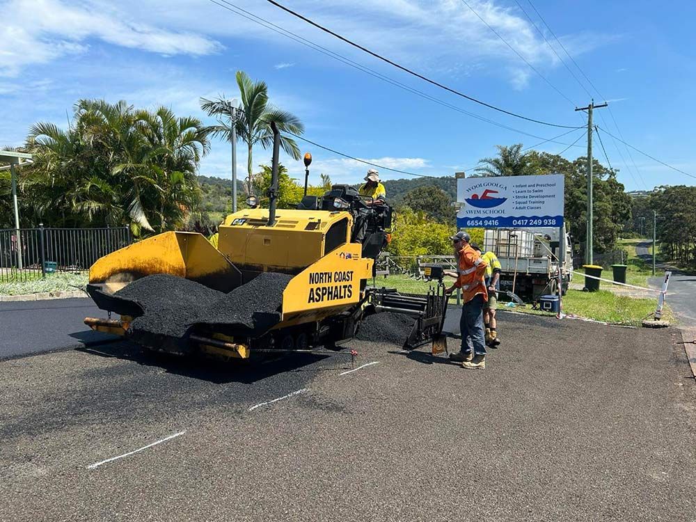 A Group of Construction Workers Are Working on a Road — North Coast Asphalts in Corindi Beach, NSW