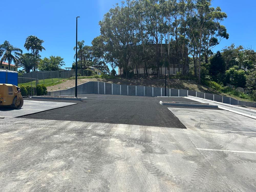 A Large Concrete Parking Lot With Trees in the Background — North Coast Asphalts in Clarence Valley, NSW