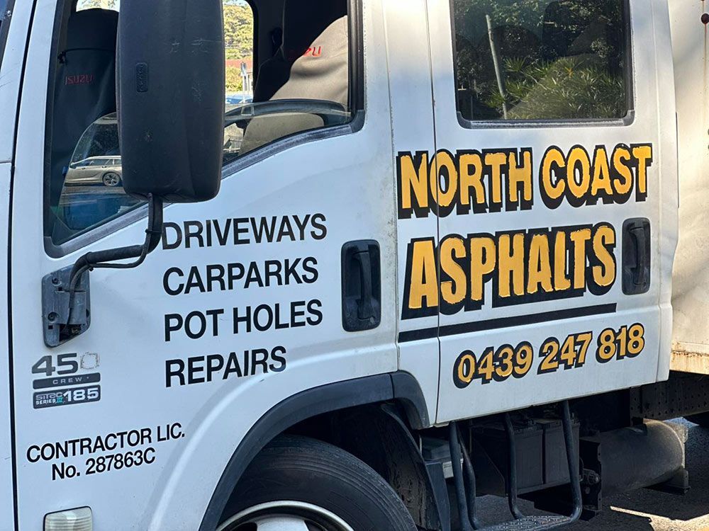 A North Coast Asphalts Truck is Parked on the Side of the Road — North Coast Asphalts in Corindi Beach, NSW 
