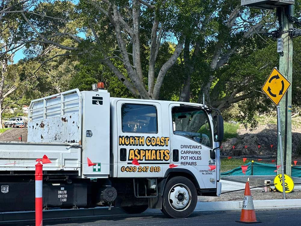 A North Coast Asphalts Truck is Parked on the Side of the Road — North Coast Asphalts in Corindi Beach, NSW
