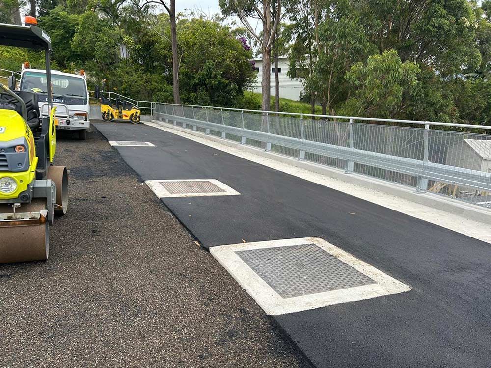 A Yellow Truck is Parked on the Side of a Road — North Coast Asphalts in Corindi Beach, NSW