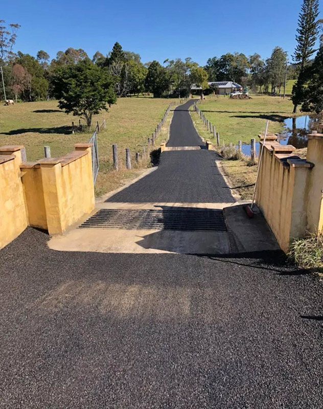 A Road That is Going Through a Field With Trees on the Side of It — North Coast Asphalts in Yamba, NSW