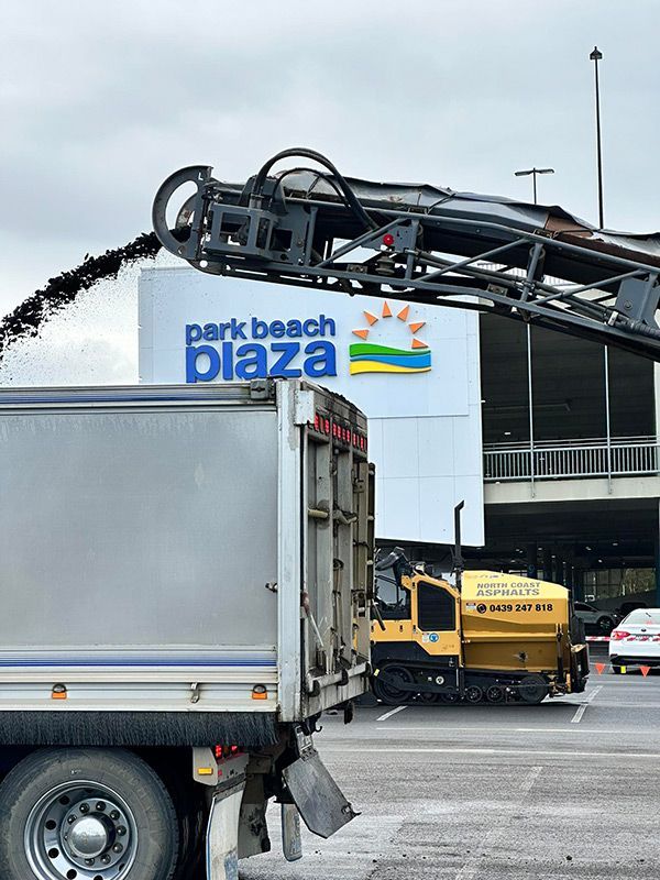 A Truck is Parked in Front of a Sign That Says Park Beach Plaza — North Coast Asphalts in Corindi Beach, NSW