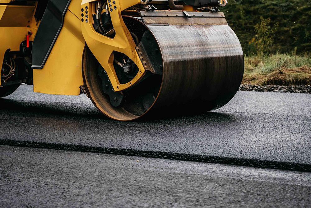 A Yellow Roller is Rolling Asphalt on a Road — North Coast Asphalts in Corindi Beach, NSW