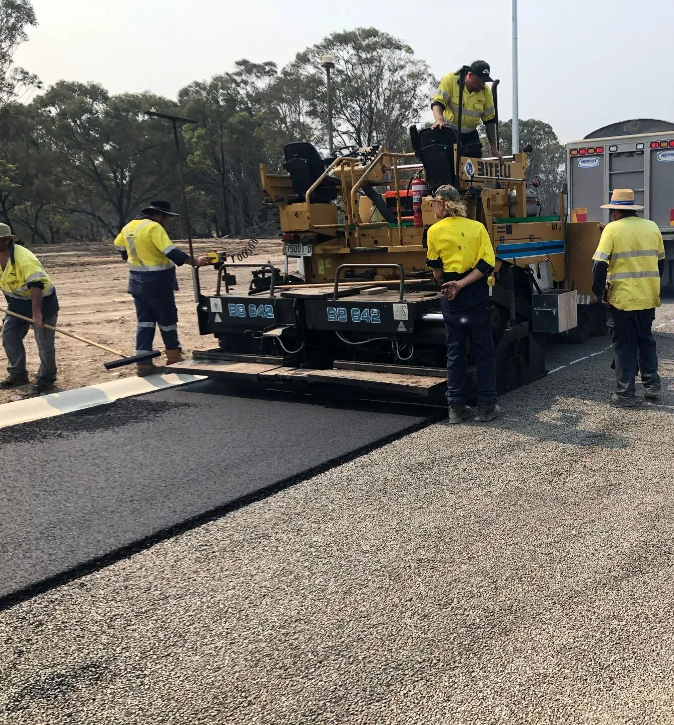 A large machine is on a freshly laid road— North Coast Asphalts in Corindi Beach, NSW