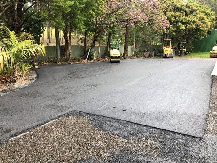 A Roller is Rolling Asphalt on a Road in a Parking Lot — North Coast Asphalts in Corindi Beach, NSW