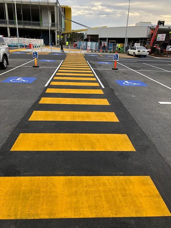 A Yellow and Black Crosswalk in a Parking Lot — North Coast Asphalts in Corindi Beach, NSW