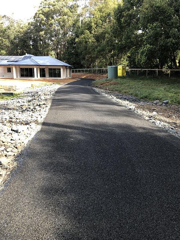 A House is Being Built on the Side of a Road — North Coast Asphalts in Corindi Beach, NSW