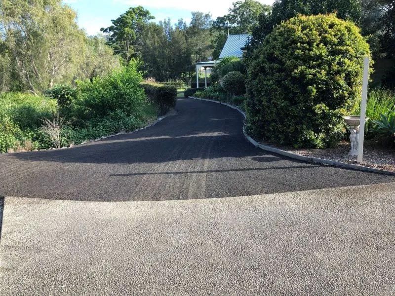 A Driveway With a White House in the Background — North Coast Asphalts in Corindi Beach, NSW