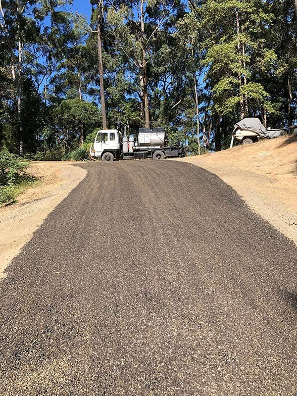 A Truck is Parked on the Side of a Dirt Road — North Coast Asphalts in Corindi Beach, NSW