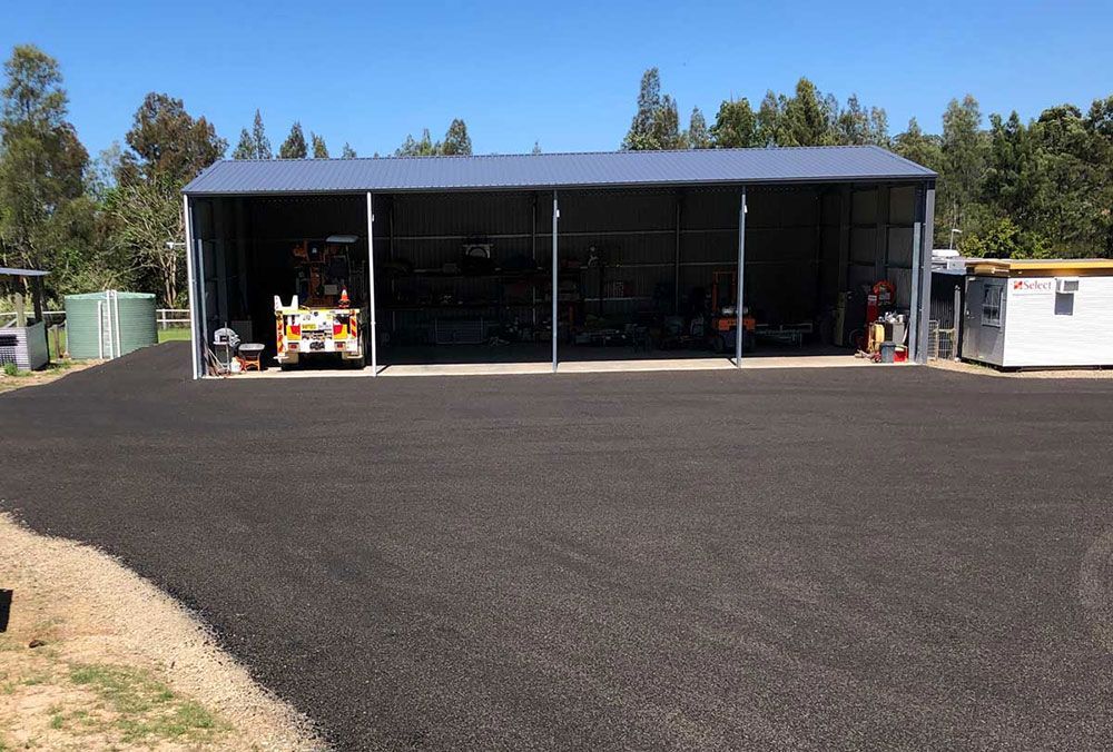A Large Building With a Lot of Windows and a Truck Parked in Front of It — North Coast Asphalts in Corindi Beach, NSW