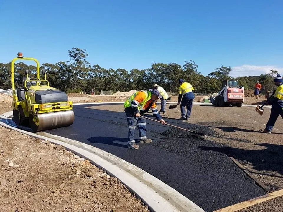 A Group of Construction Workers Are Working on a Road — North Coast Asphalts in Corindi Beach, NSW